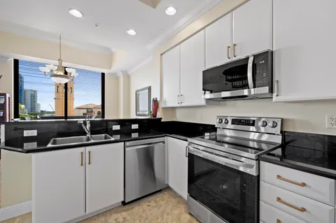 a kitchen with a sink and refrigerator