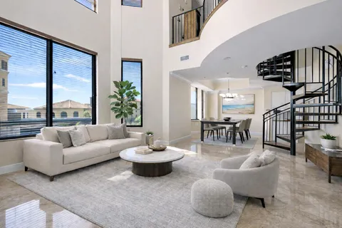 a living room with furniture and a floor to ceiling window