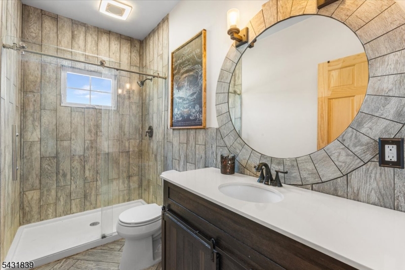 15 Spring Hunter Court Andover, NJ 07821 - Photo 28 of 49 a bathroom with a sink a toilet and shower