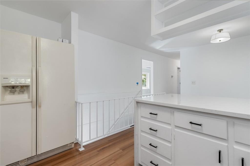 2958 Harcourt Drive, Unit 1 Decatur, GA 30033 - Photo 11 of 32 a kitchen with white cabinets and wooden floor