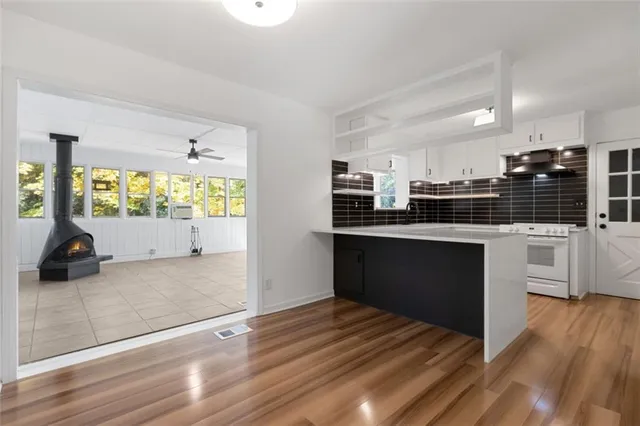 a kitchen with stainless steel appliances kitchen island granite countertop a refrigerator and a sink