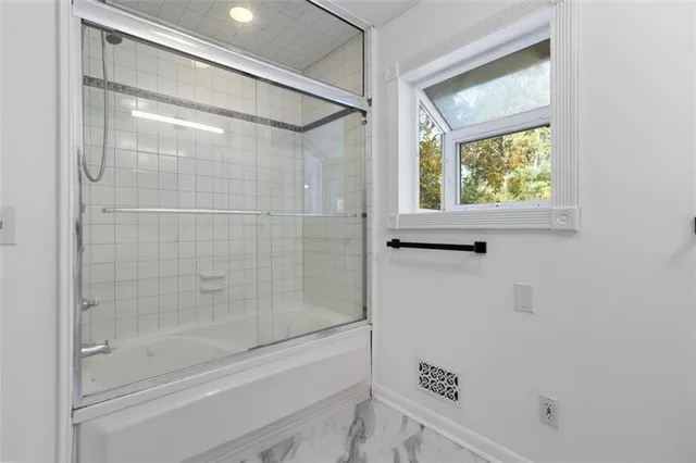 a bathroom with a shower and a sink