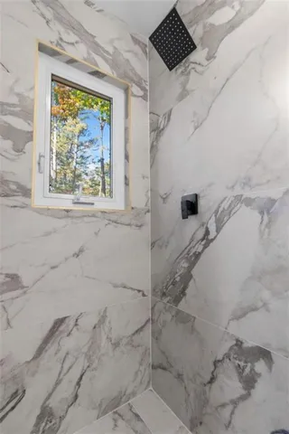 a bathroom with a tub and shower