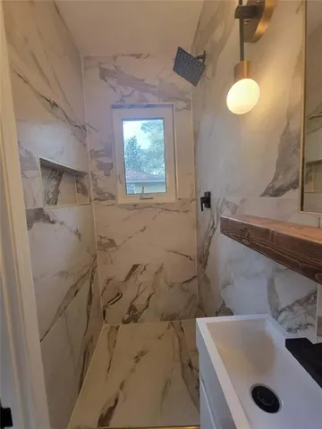 a bathroom with a sink and shower