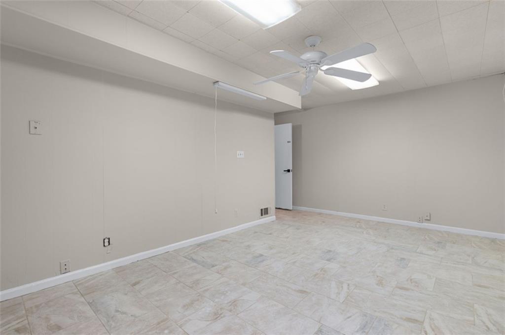 2958 Harcourt Drive, Unit 1 Decatur, GA 30033 - Photo 28 of 32 an empty room with a ceiling fan and window