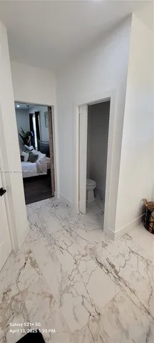 a white toilet sitting next to a white cabinet