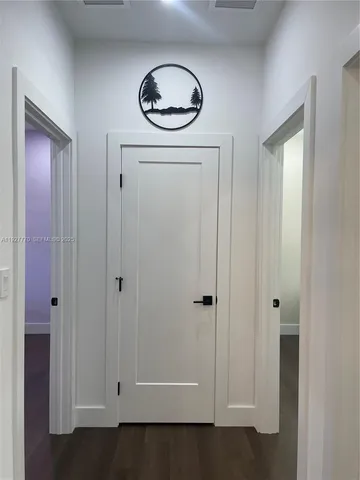 a view of hallway with wooden floor