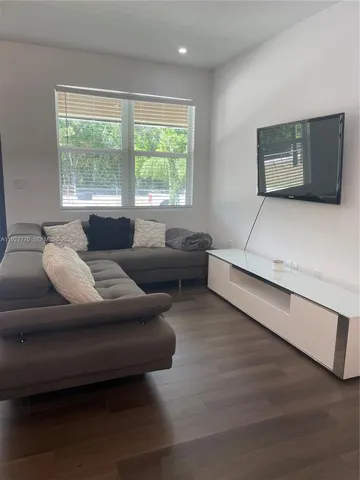 a living room with furniture and a large window