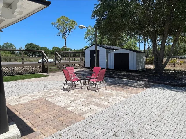 a view of a house with backyard and sitting area