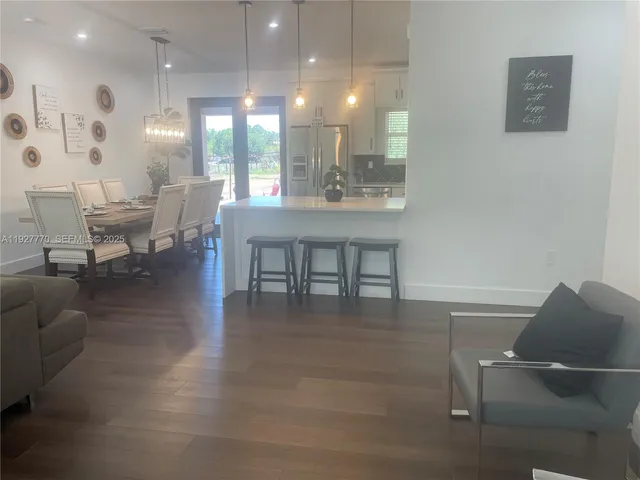 a dining room with furniture and wooden floor