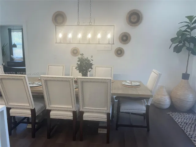 a view of a dining room with furniture and chandelier