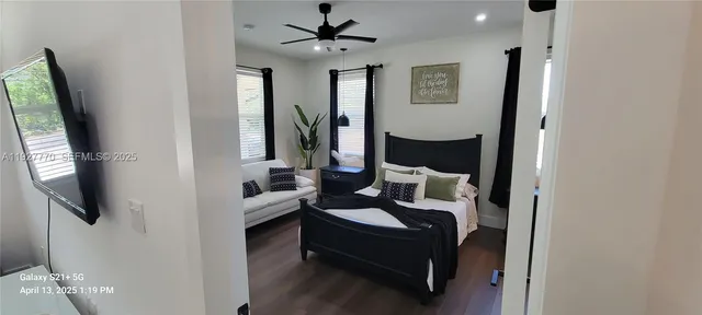 a bedroom with a bed couch and window