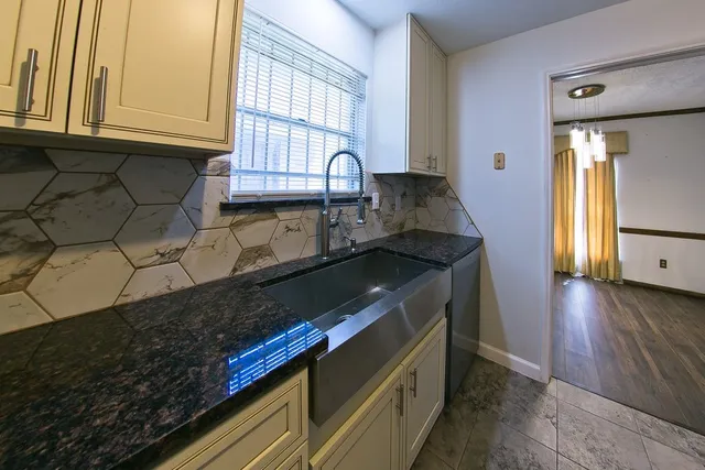 a kitchen with stainless steel appliances granite countertop a refrigerator stove and cabinets