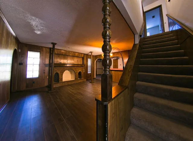 a hallway with couches and wooden floor