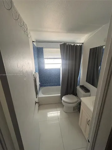 a bathroom with a sink a toilet and tub