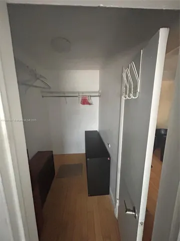 a balcony with table chair and wooden floor