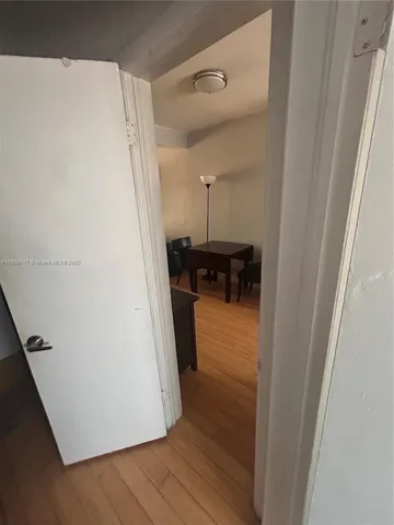 a view of living room with furniture and wooden floor