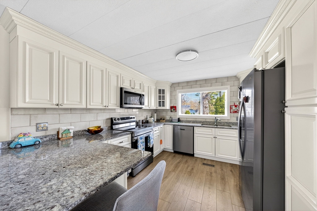 19 Timber Lane Wareham, MA 02571 - Photo 7 of 38 a kitchen with sink a stove and cabinets