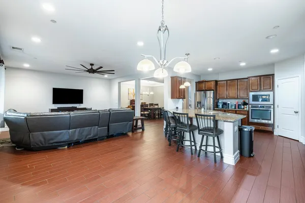 a living room with furniture and a wooden floor