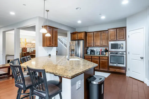 a kitchen with a table chairs sink and cabinets