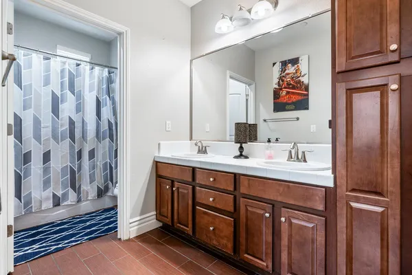 a bathroom with a sink vanity and mirror
