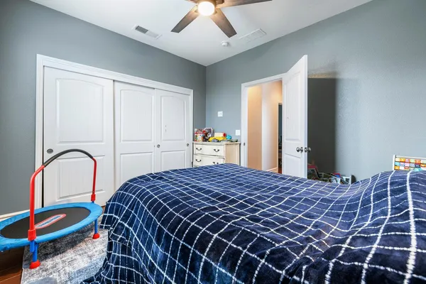 a bedroom with a bed and a dresser