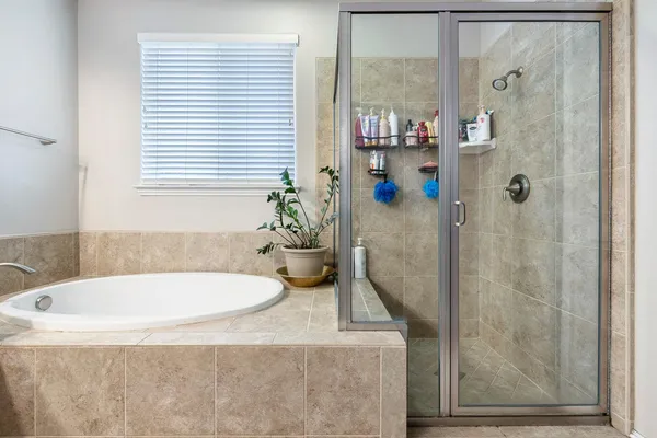 a bathroom with a tub and shower