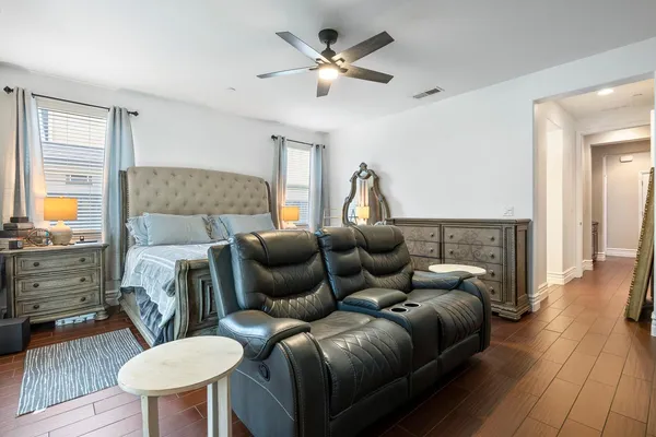 a living room with furniture and a wooden floor