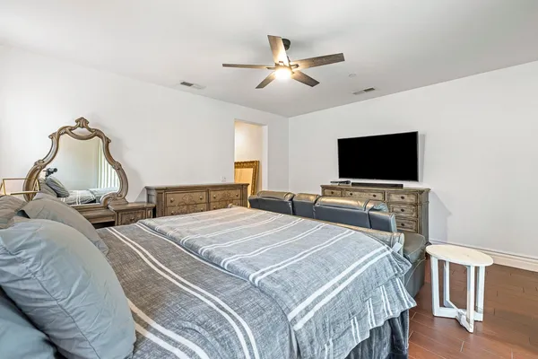a bedroom with a bed and a flat screen tv