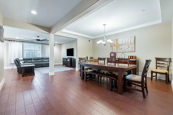 a view of a dining room with furniture and wooden floor