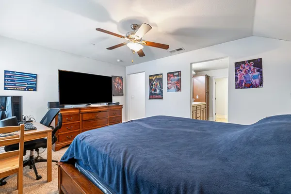 a bedroom with a bed and a flat screen tv