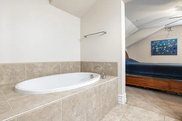 a bathroom with a tub and a shower