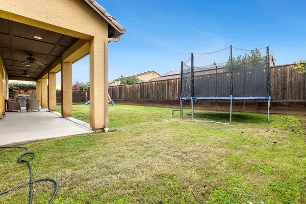 a view of a backyard with a garden and deck