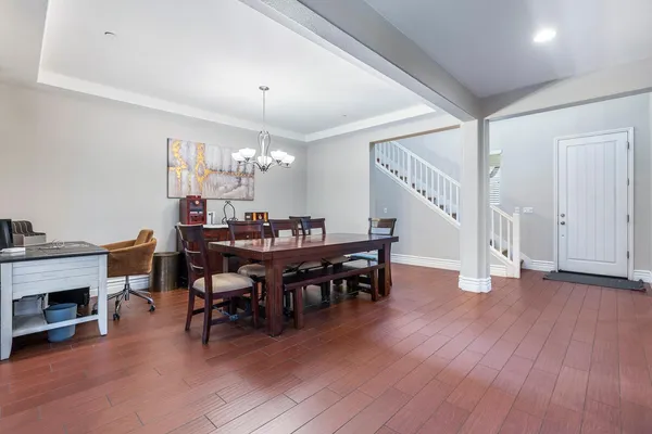 a view of a dining room with furniture and wooden floor