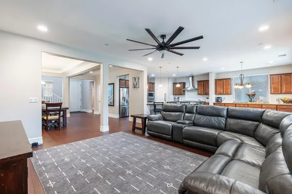 a living room with furniture and a view of kitchen