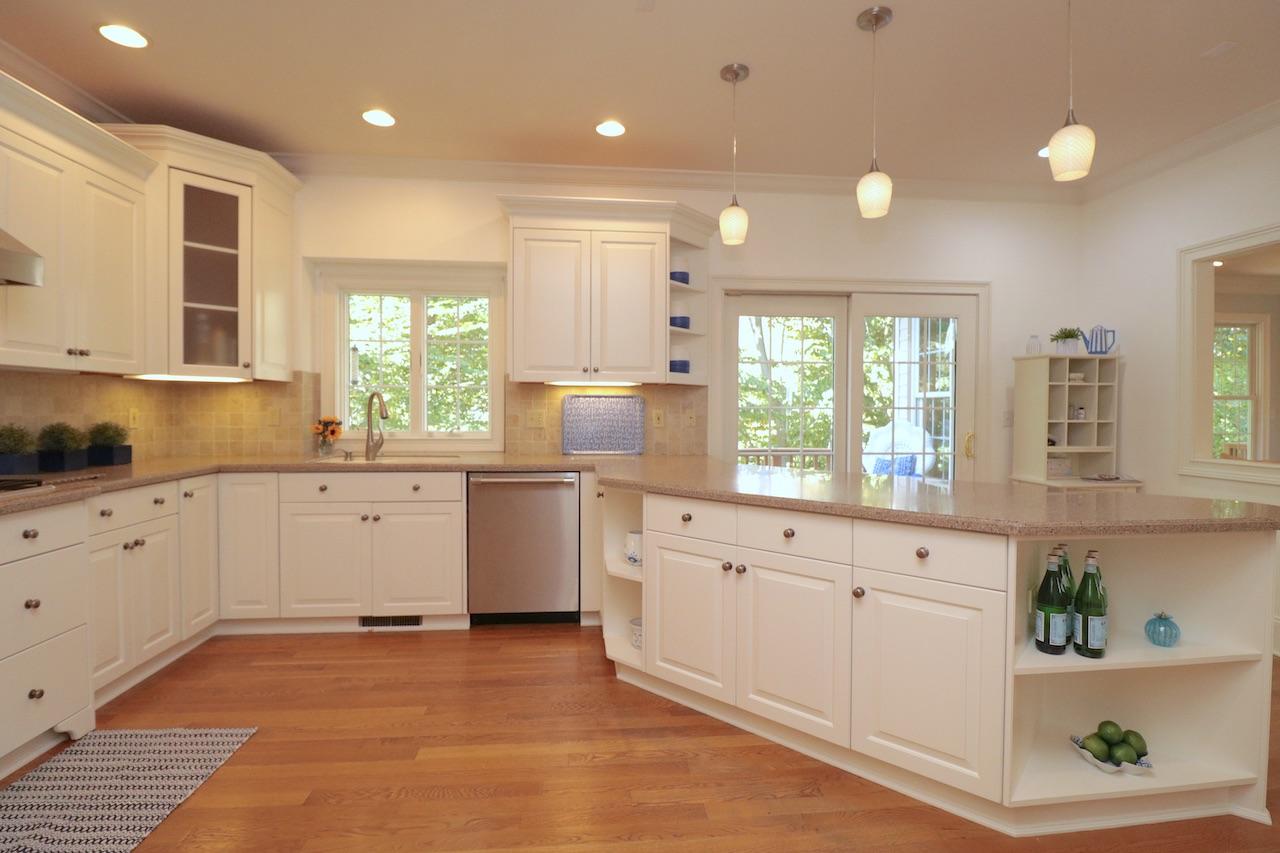 32 Briar Street Rowayton, CT 06853 - Photo 11 of 40 a kitchen with white cabinets a sink dishwasher and a stove with wooden floor