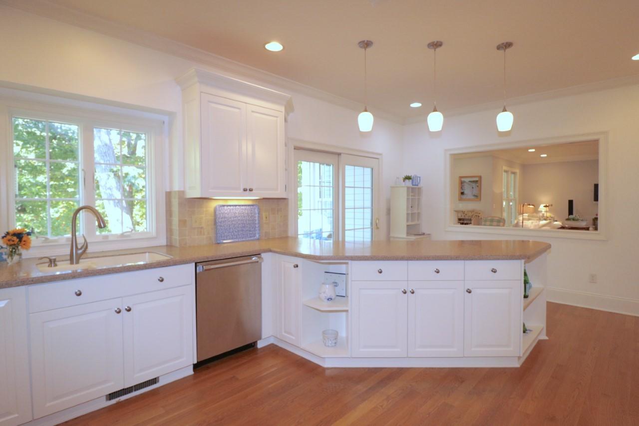 32 Briar Street Rowayton, CT 06853 - Photo 12 of 40 a large kitchen with granite countertop a large window and white cabinets