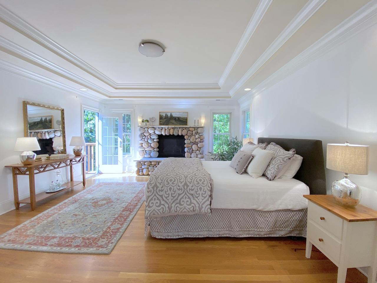 32 Briar Street Rowayton, CT 06853 - Photo 17 of 40 a spacious bedroom with a large bed and a flat tv screen on dresser