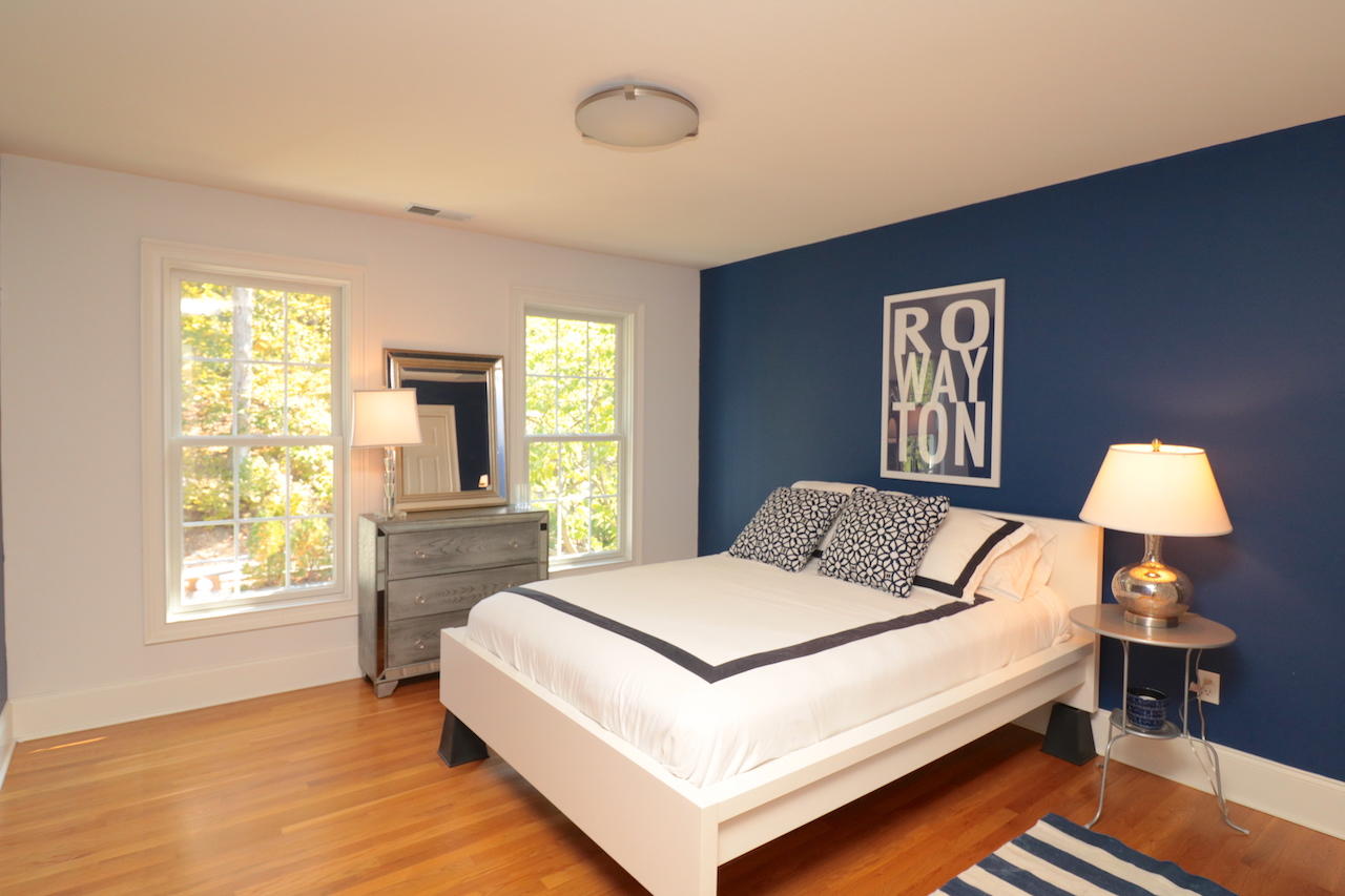 32 Briar Street Rowayton, CT 06853 - Photo 21 of 40 a bedroom with a bed and a lamp next to a window