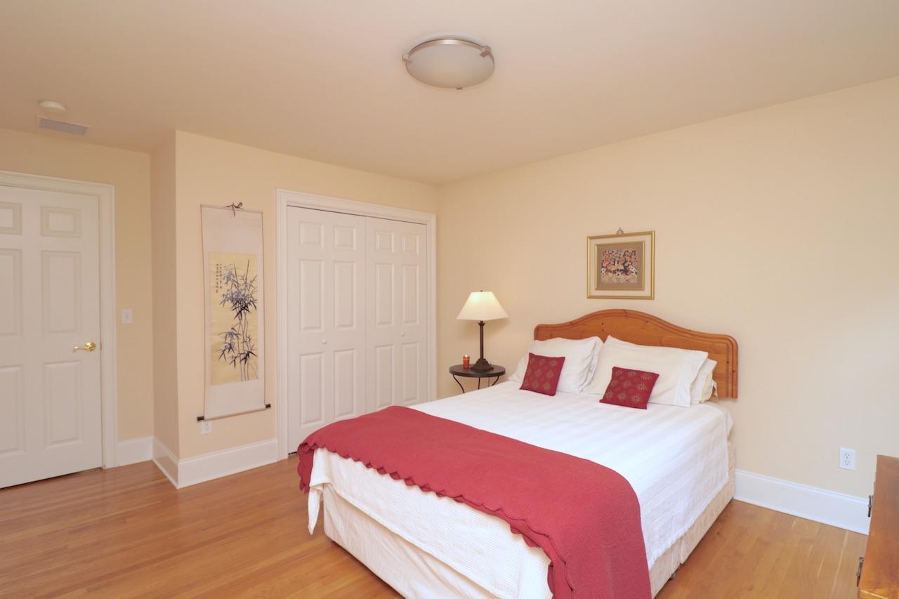 32 Briar Street Rowayton, CT 06853 - Photo 24 of 40 a bedroom with a bed and wooden floor