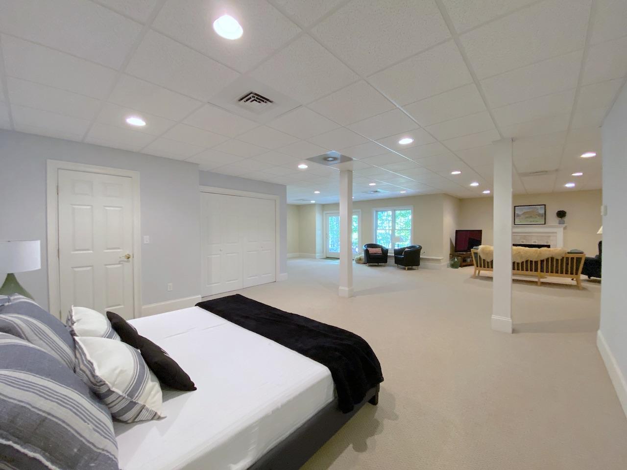 32 Briar Street Rowayton, CT 06853 - Photo 30 of 40 a large bedroom with a bed and a large mirror