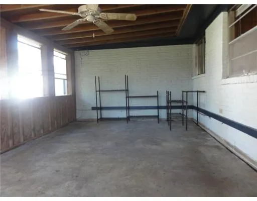a view of a yard with large trees and a barn