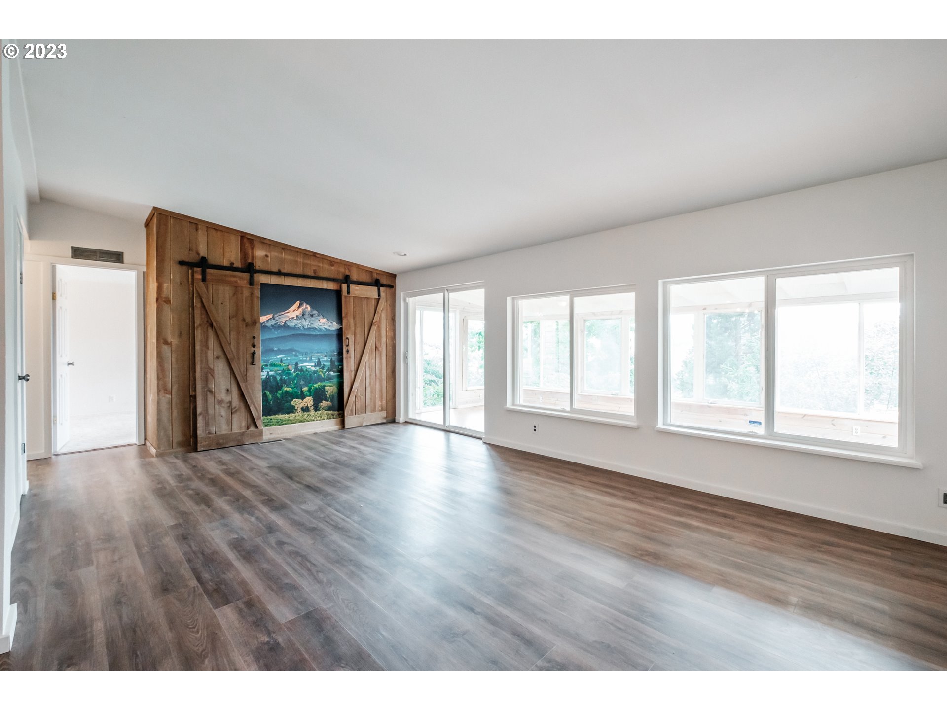 524 6th Street Scotts Mills, OR 97375 - Photo 11 of 41 a view of an empty room with wooden floor and a window