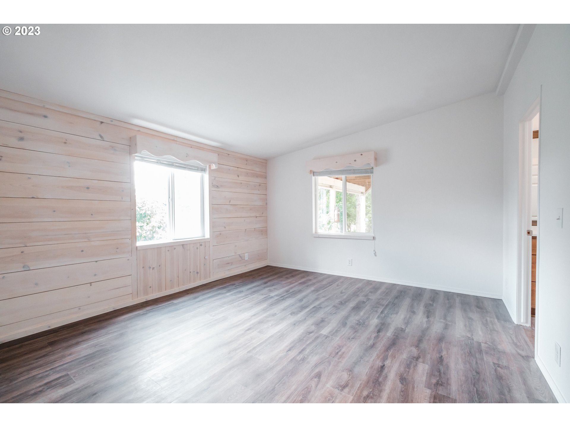 524 6th Street Scotts Mills, OR 97375 - Photo 13 of 41 an empty room with wooden floor and windows