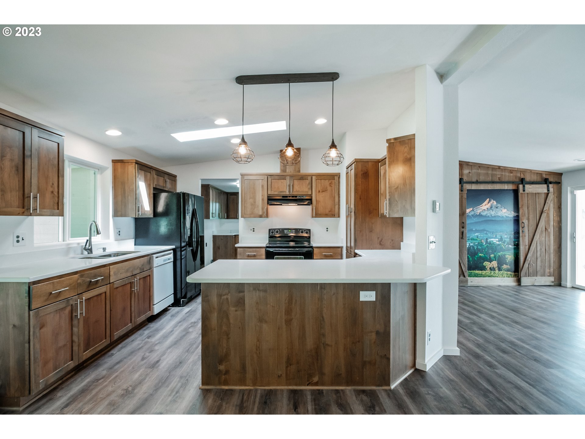 524 6th Street Scotts Mills, OR 97375 - Photo 5 of 41 a kitchen with stainless steel appliances granite countertop a stove top oven a sink dishwasher and a refrigerator with wooden floor