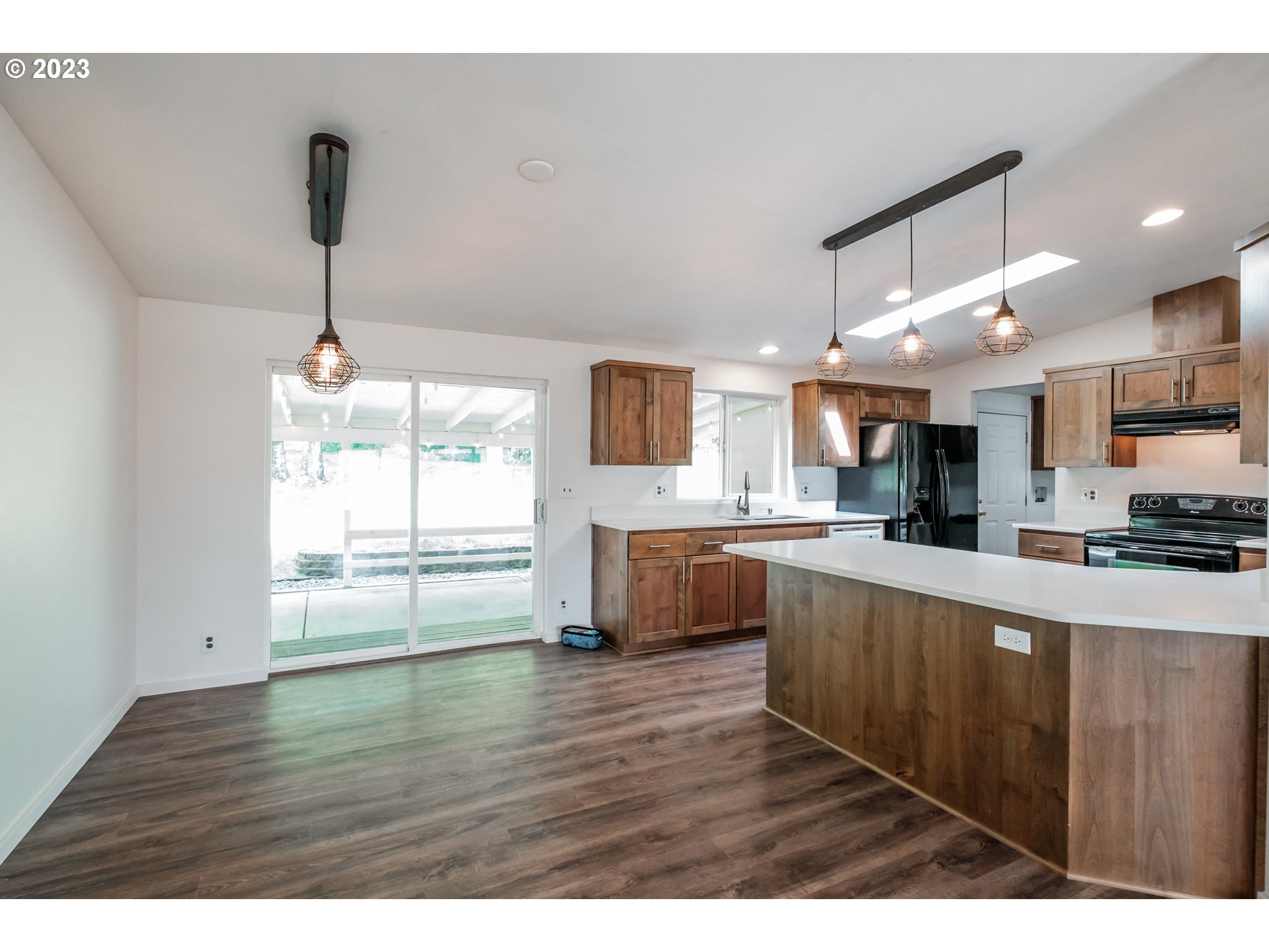 524 6th Street Scotts Mills, OR 97375 - Photo 9 of 41 a kitchen with stainless steel appliances granite countertop a sink window and a wooden floor