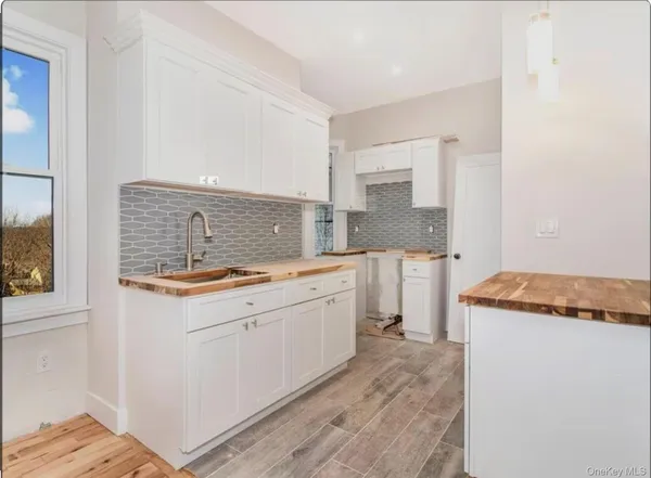 a spacious bathroom with a granite countertop sink and a mirror