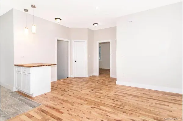 a view of a bedroom with wooden floor and bathroom