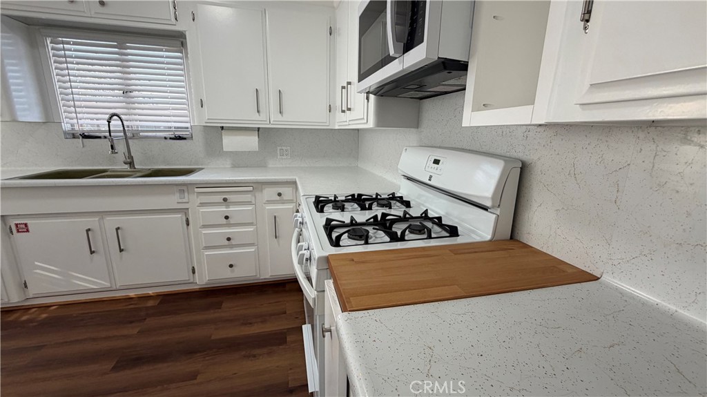 3590 Buchanan Street Riverside, CA 92503 - Photo 18 of 73 a view of a kitchen with sink and wooden floor