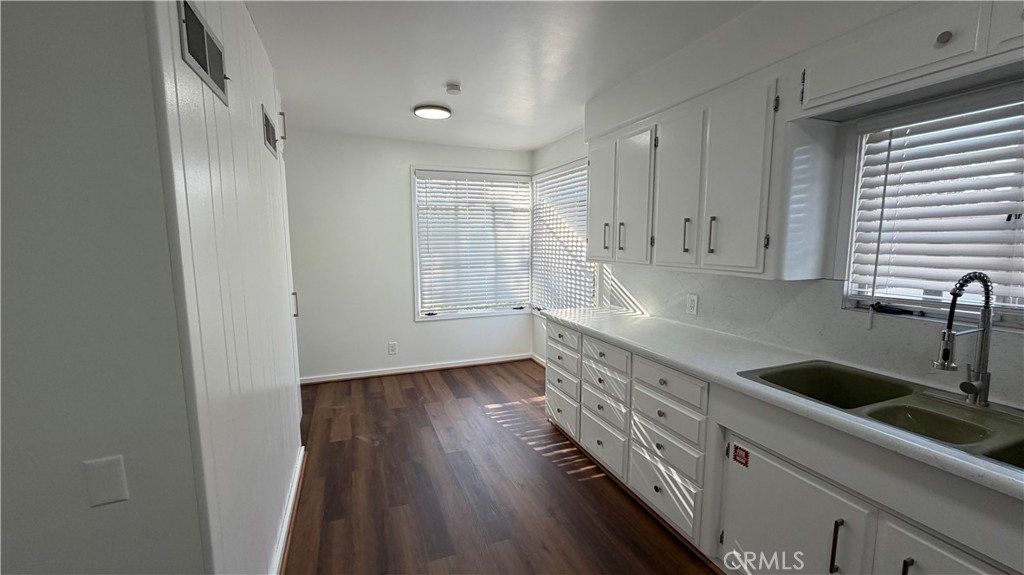 3590 Buchanan Street Riverside, CA 92503 - Photo 21 of 73 a kitchen with granite countertop white cabinets and a wooden floor